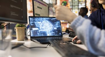 Call center worker using AI chatbot to provide quick replies to common customer queries, close up. Customer service agent generates automated responses to clients using artificial intelligence